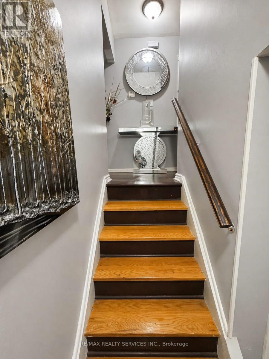 A staircase with wooden steps and a metal handrail.