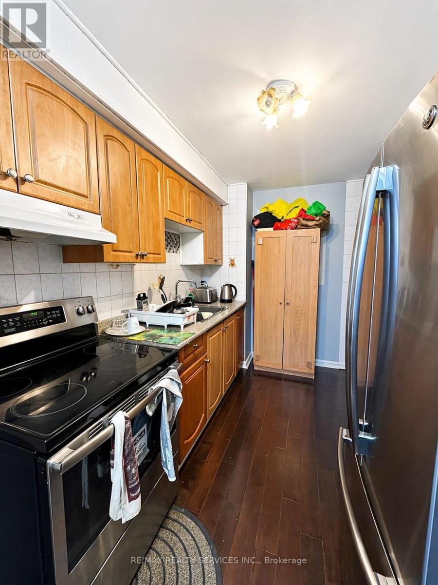 A kitchen with wooden cabinets and a black stove top.