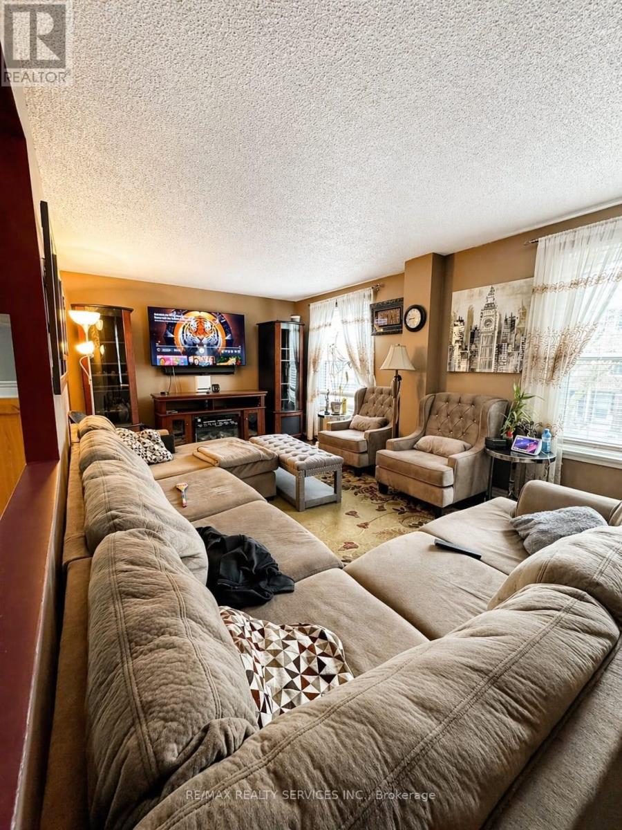 A living room with a large couch and a flat screen TV.