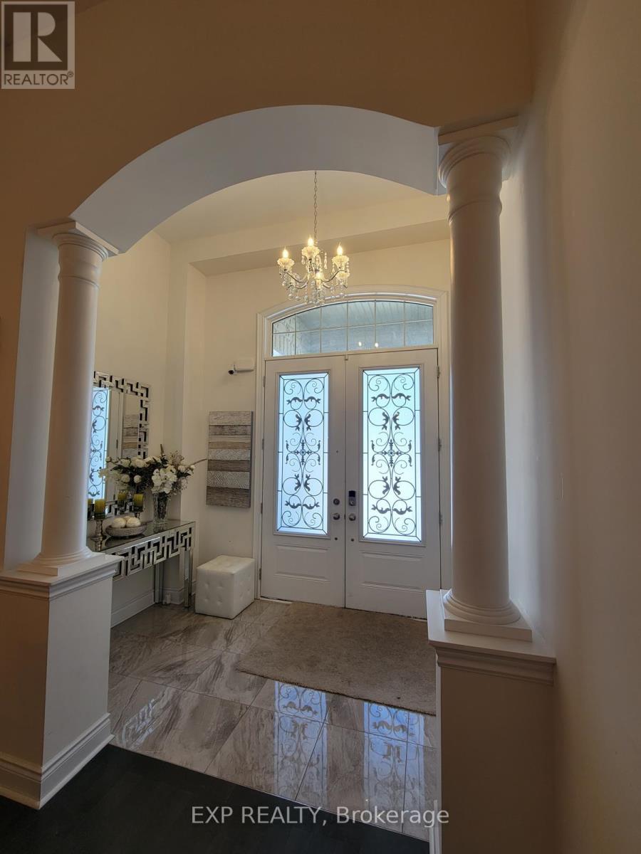 A foyer with a chandelier, a bench, and a door with a glass panel.