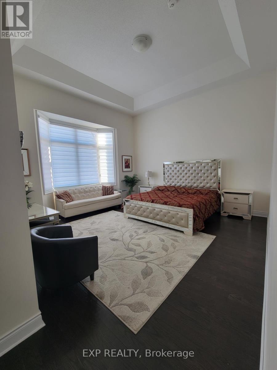 A bedroom with a bed, chair, and window.