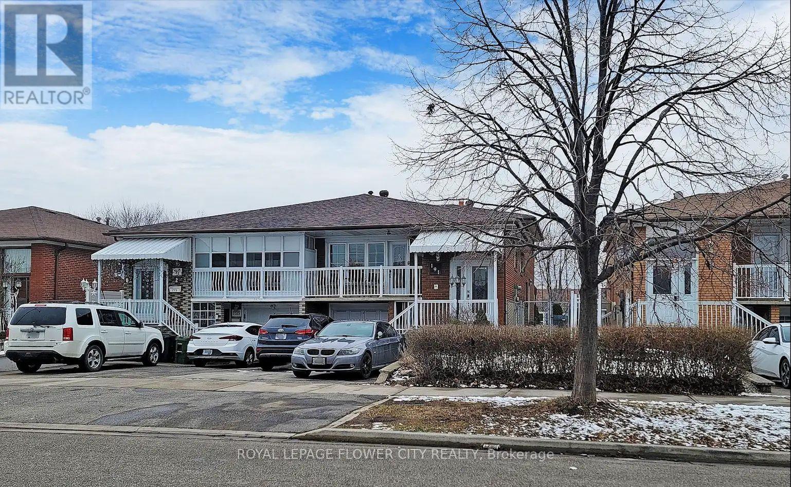 A parking lot with cars and a building in the background.