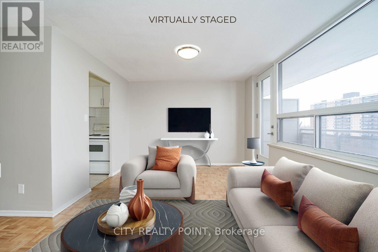 A living room with a flat screen TV mounted on the wall.