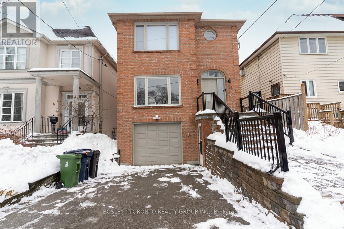 A house with a snow-covered front yard and a sign that says "REALTOR".