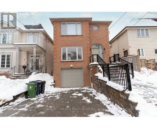 A house with a snow-covered front yard and a sign that says "REALTOR".