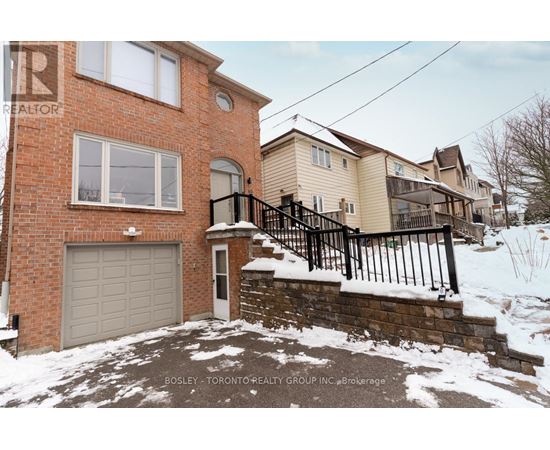 A house with a brick exterior and a garage door is for sale.