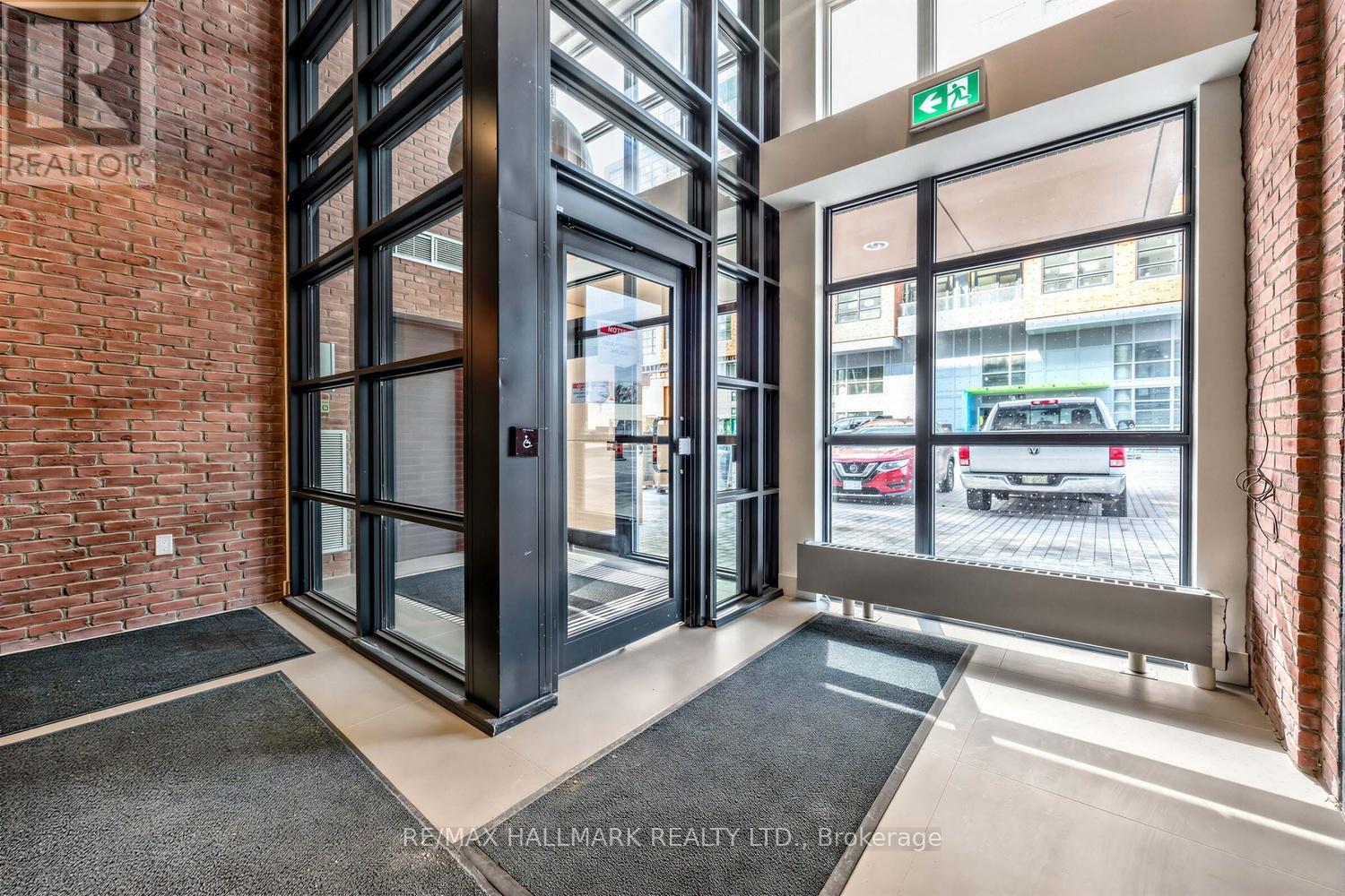 A black door with a glass window and a sign above it.