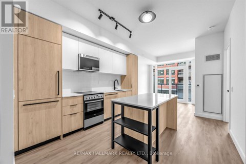 A modern kitchen with wooden cabinets and a black and white table.