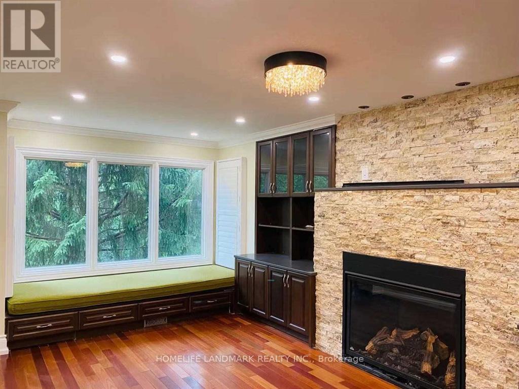 A living room with a fireplace and a chandelier.