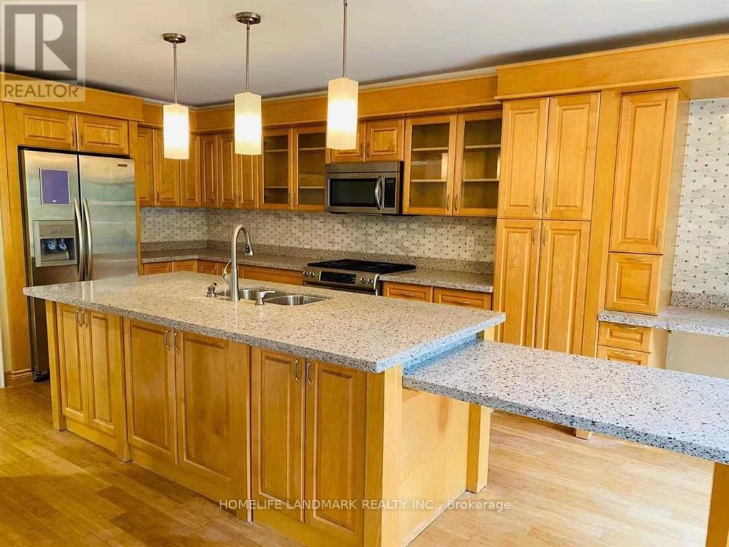 A kitchen with wooden cabinets and granite countertops.