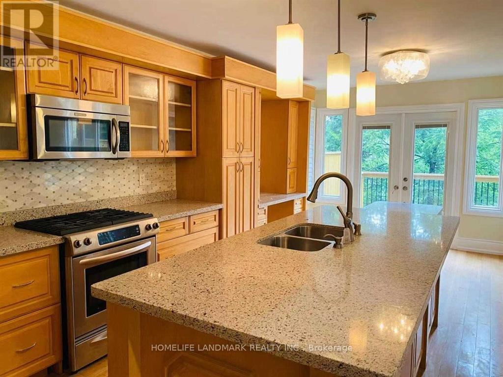 A kitchen with granite countertops and wooden cabinets.
