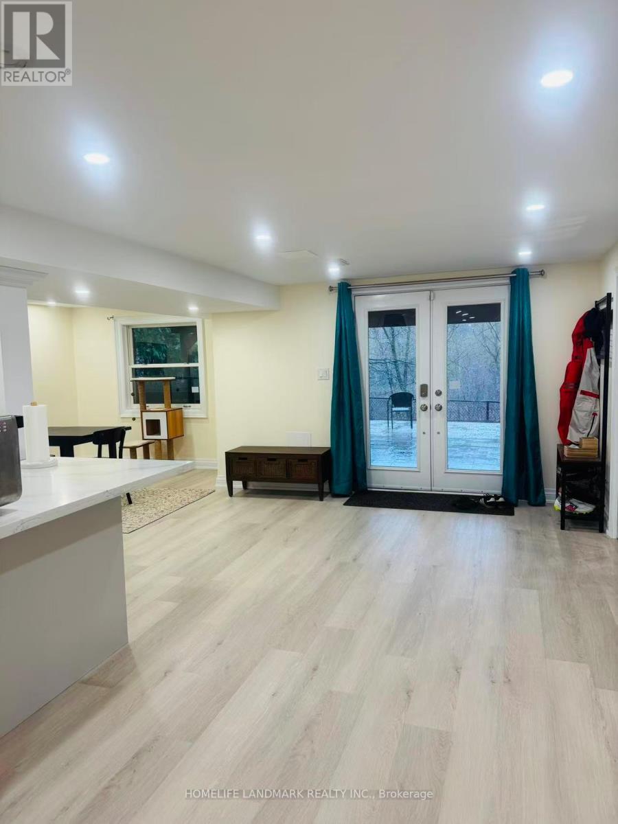 A spacious room with a white counter and a large window with blue curtains.