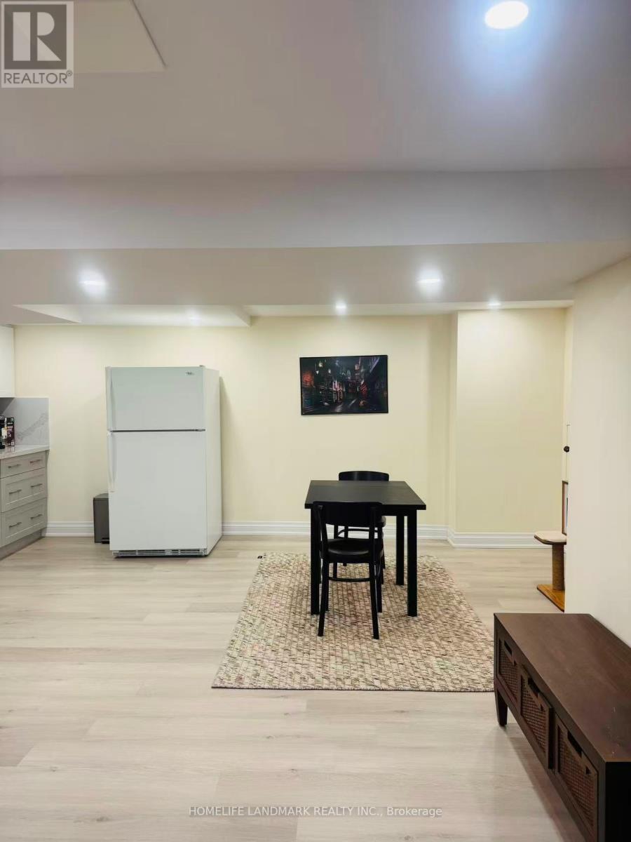 A dining room with a black table and chairs.