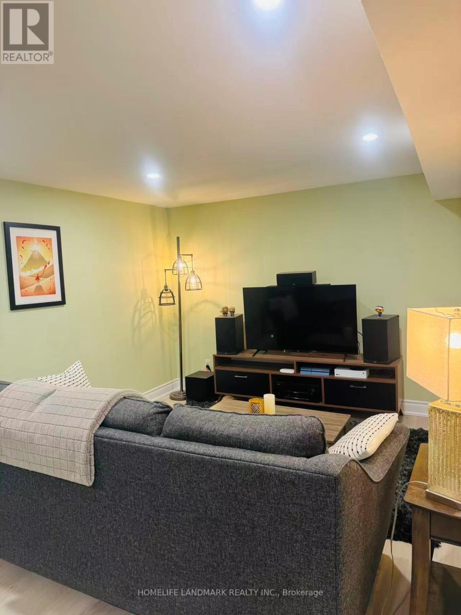A bedroom with a bed, a television, and a lamp.