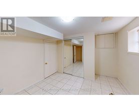 A spacious room with a door and a mirror on the wall.