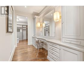 A well-lit, spacious room with a desk and a chair.