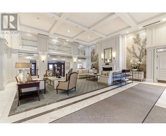 A well-lit, spacious living room with a large rug and a variety of seating options.