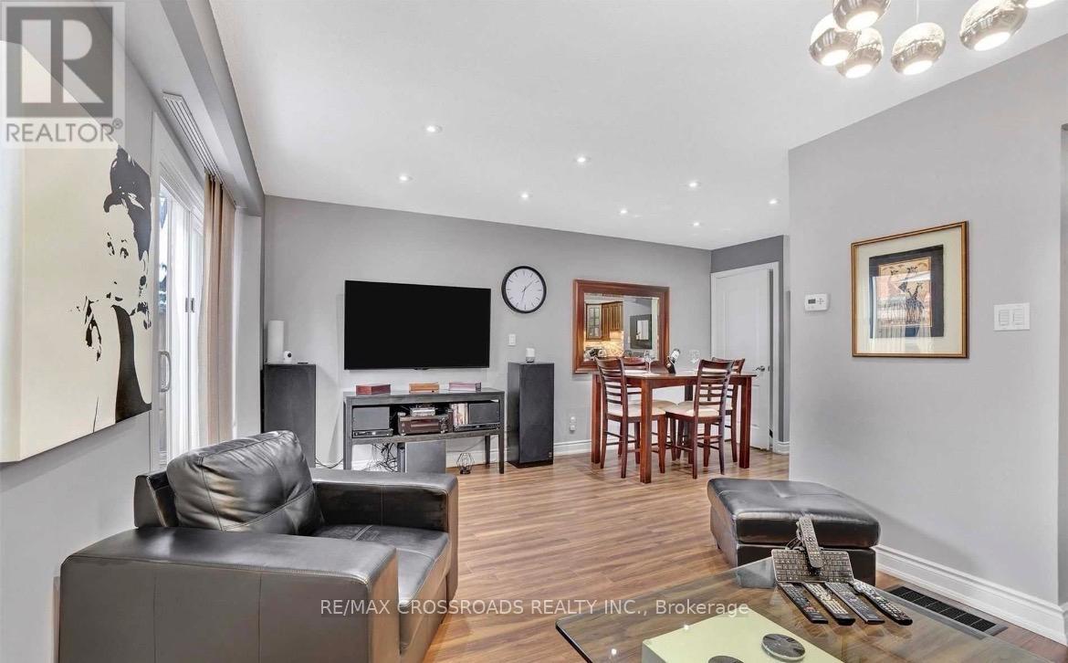 A modern living room with a grey sofa and a wooden floor.
