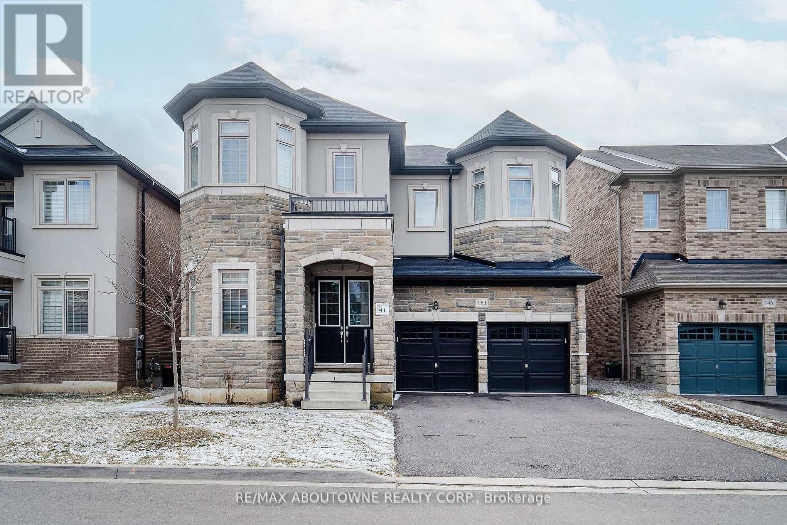 A large, two-story house with a garage is for sale.