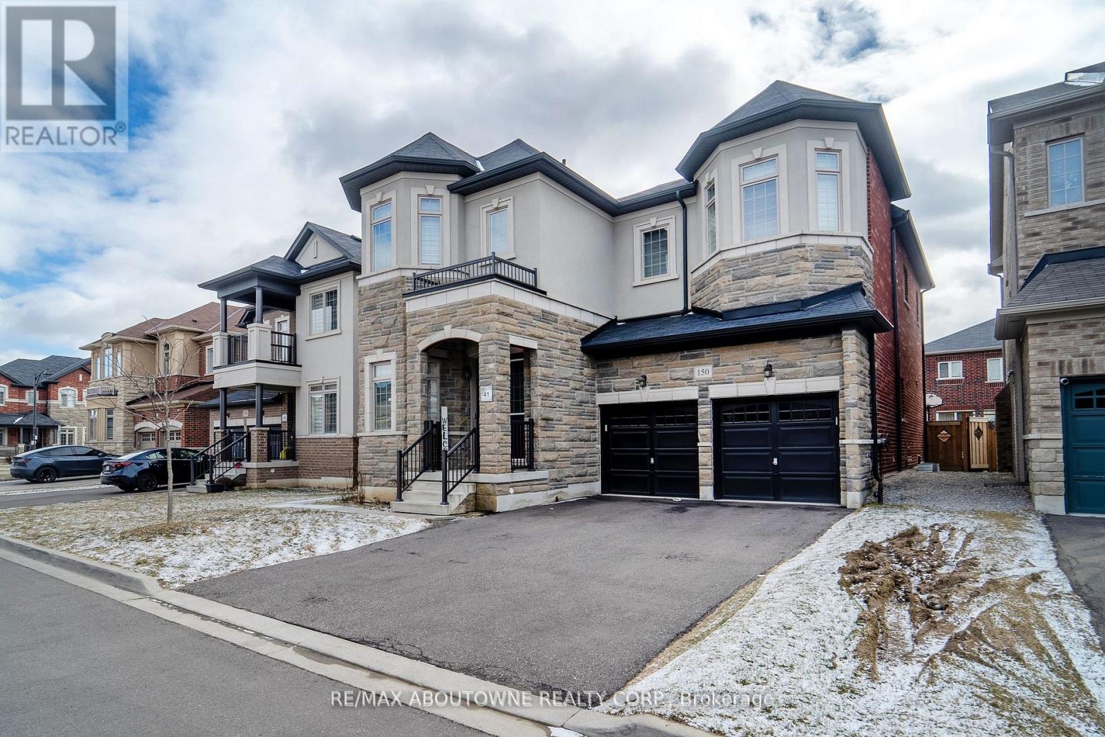 A large house with a garage is situated in a residential area.