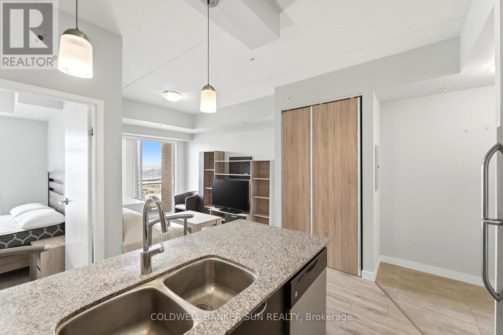 A modern kitchen with a sink and a refrigerator.