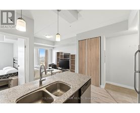A modern kitchen with a sink and a refrigerator.