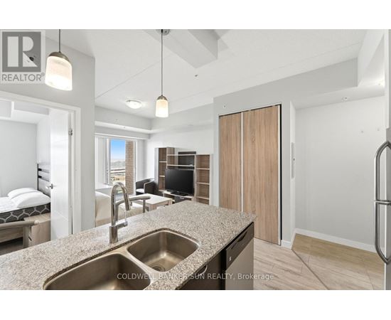 A modern kitchen with a sink and a refrigerator.