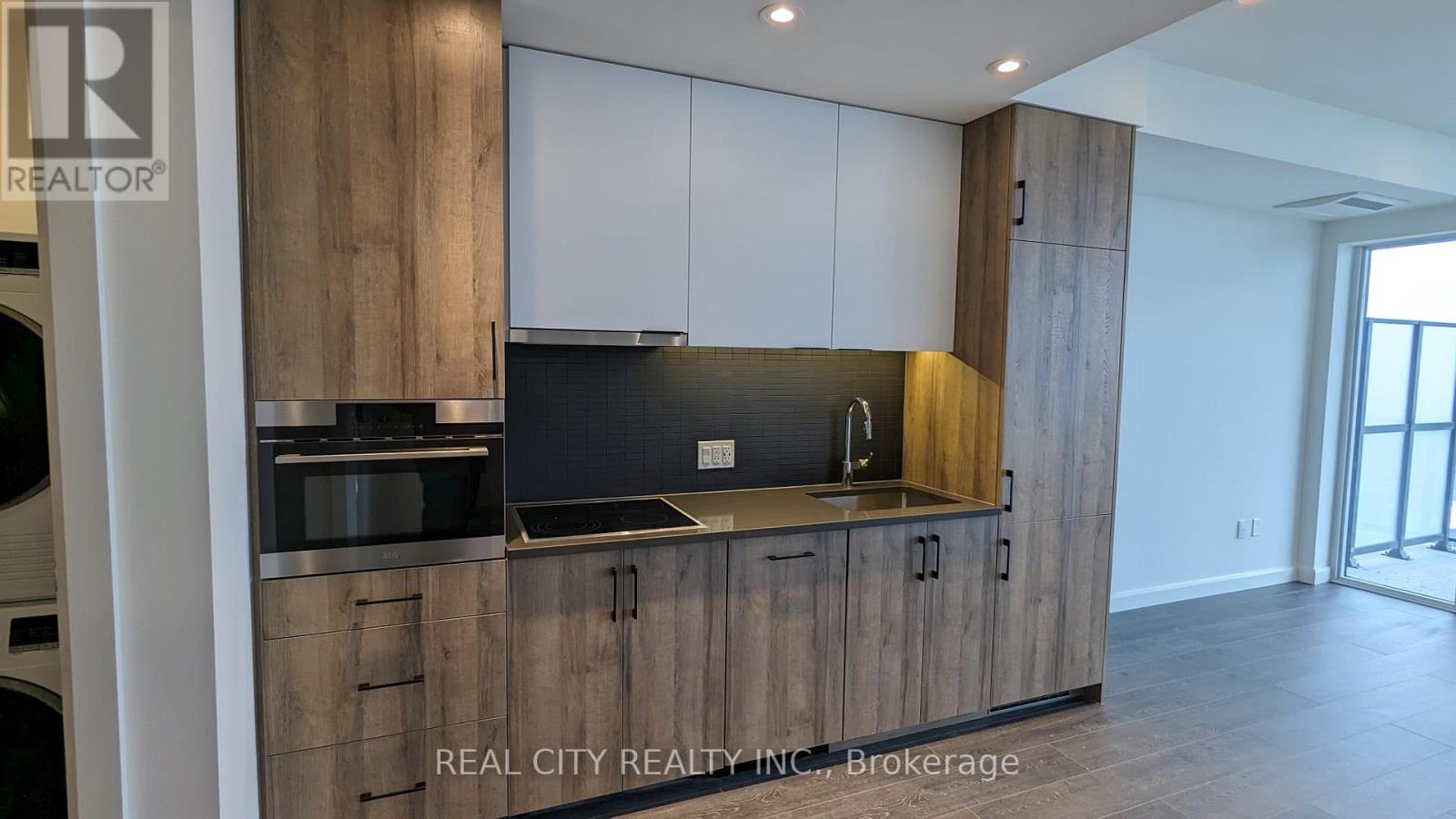 A modern kitchen with wooden cabinets and a stainless steel countertop.