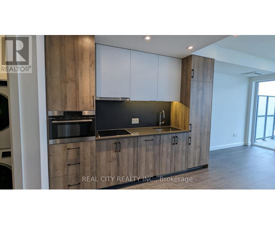 A modern kitchen with wooden cabinets and a stainless steel countertop.