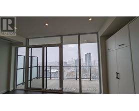 A room with a view of the city through large windows.