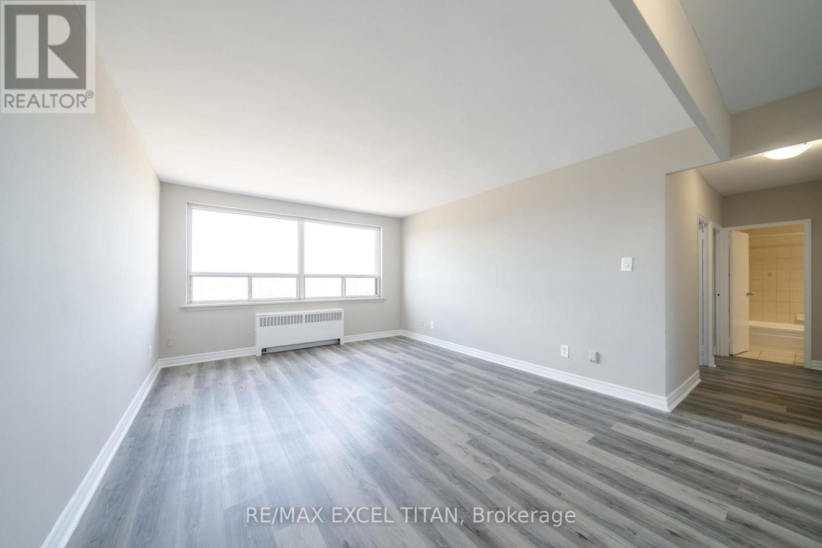 A room with a window and a radiator on the wall.