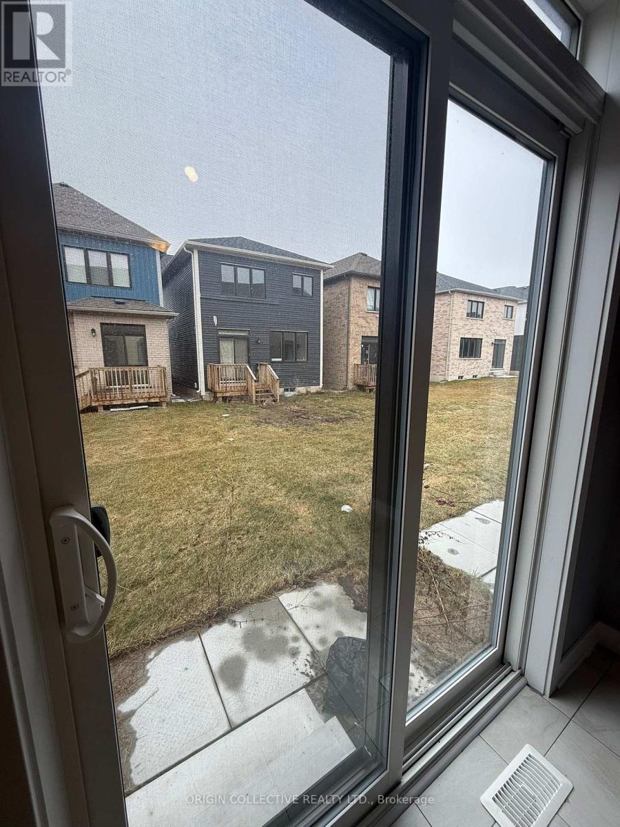A view from a window looking out at a grassy area and houses.