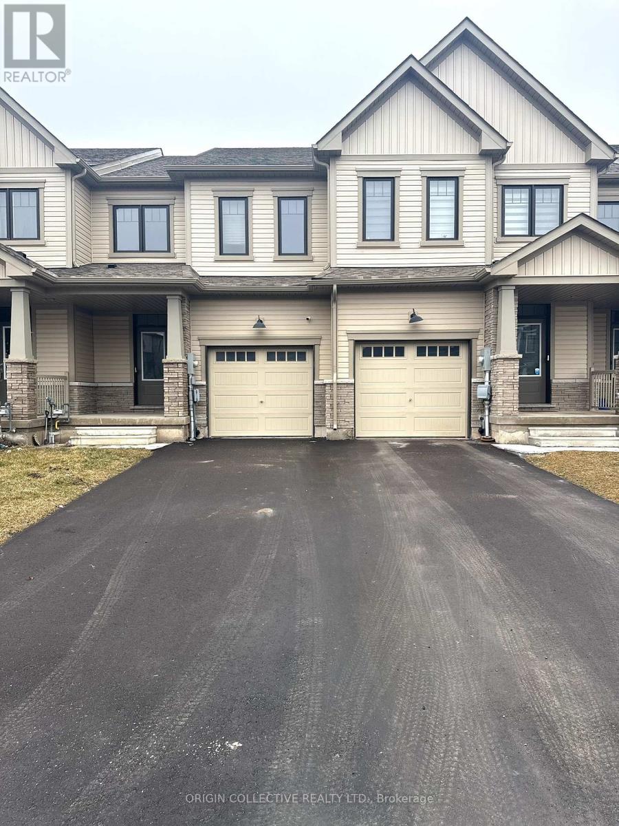 A large house with a long driveway in front.
