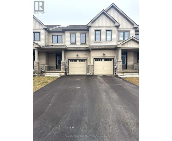 A large house with a long driveway in front.