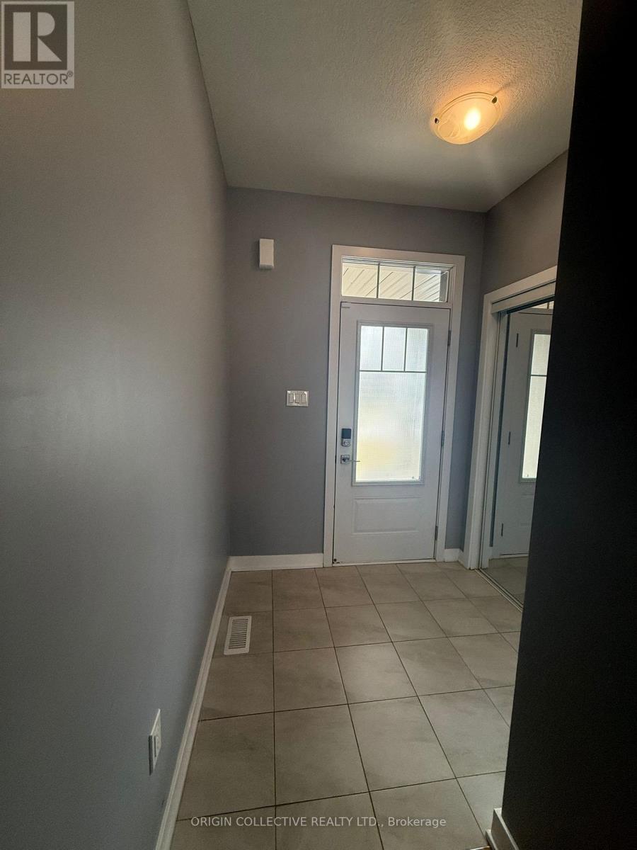 A hallway with a door and a light on the ceiling.