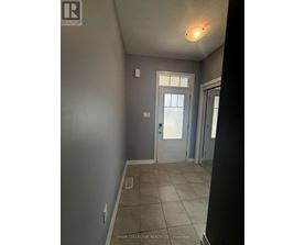 A hallway with a door and a light on the ceiling.