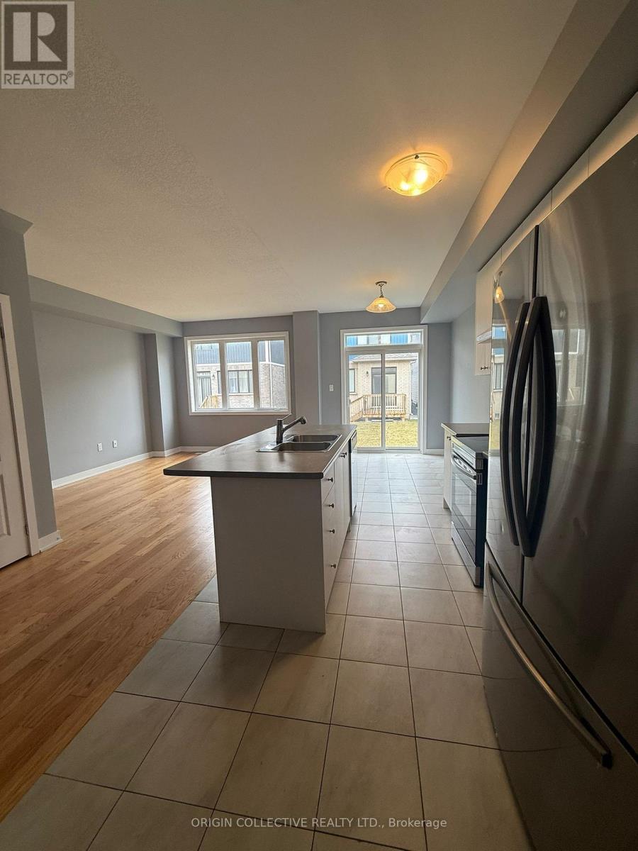 A kitchen with a refrigerator on the right side.