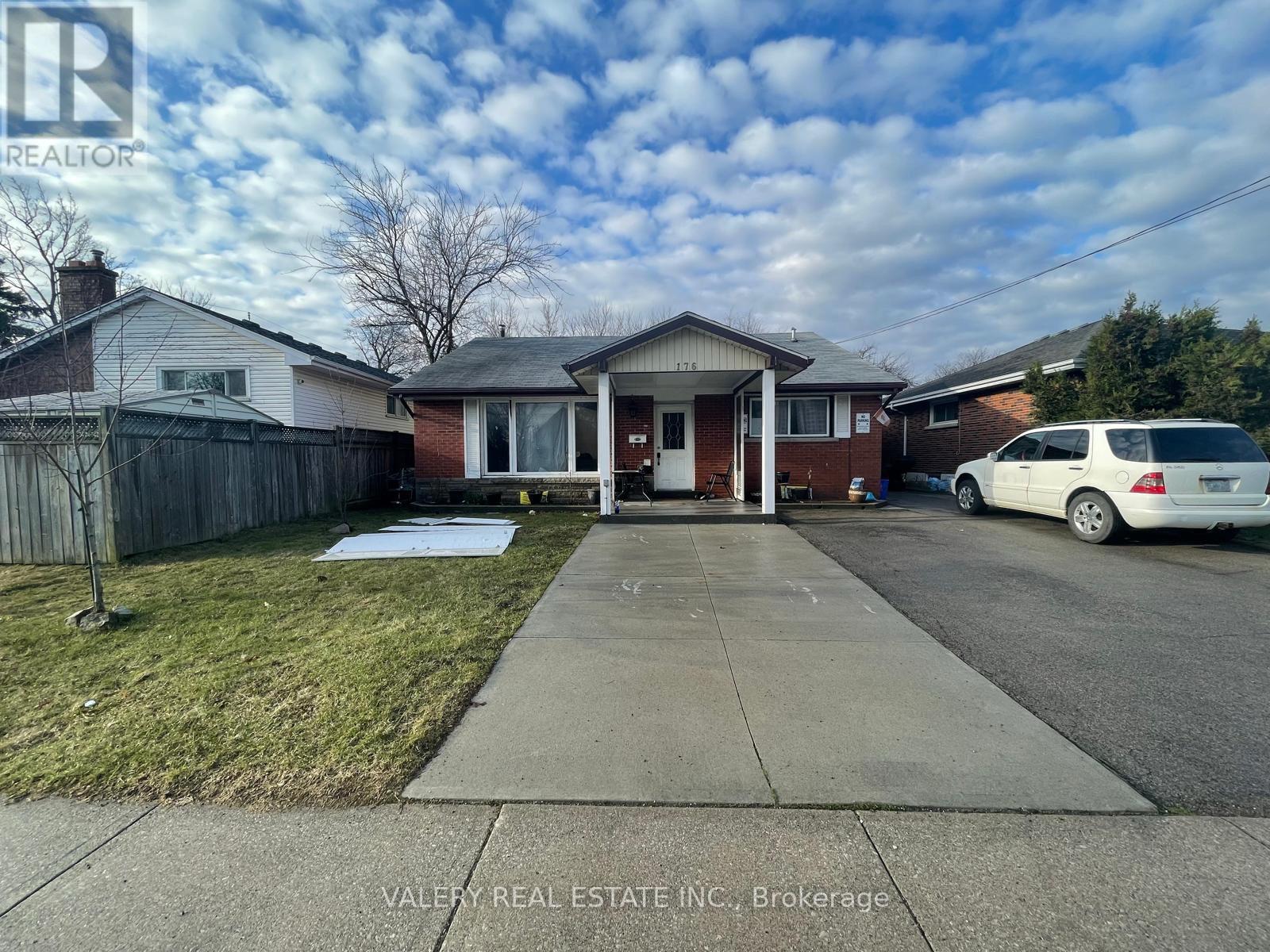 A house with a white car parked in front.