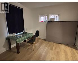 A room with a desk and chair in it.