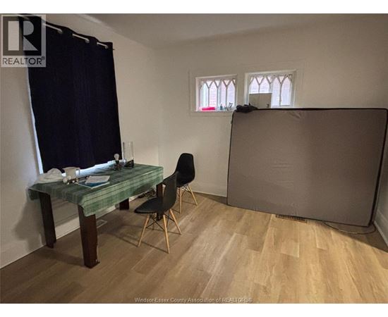 A room with a desk and chair in it.