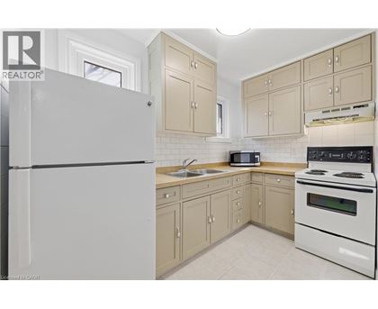A kitchen with a white refrigerator and a white stove.