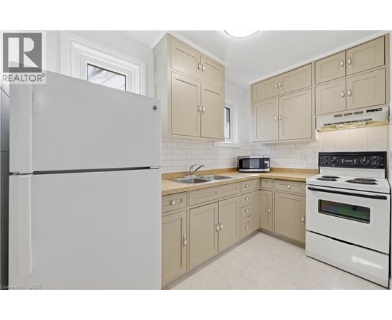A kitchen with a white refrigerator and a white stove.