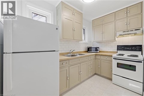 A kitchen with a white refrigerator and a white stove.