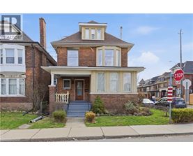 A house with a brown brick exterior and a white trim.