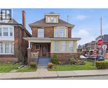 A house with a brown brick exterior and a white trim.