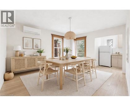 A well-lit, modern dining room with a wooden table and chairs.