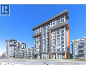 A modern multi-story residential building with a clear blue sky in the background.