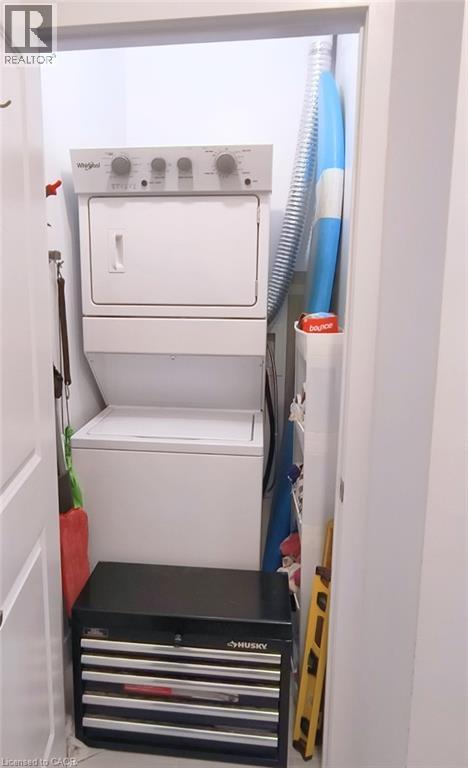 A white dishwasher is installed in a narrow kitchen.