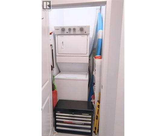 A white dishwasher is installed in a narrow kitchen.