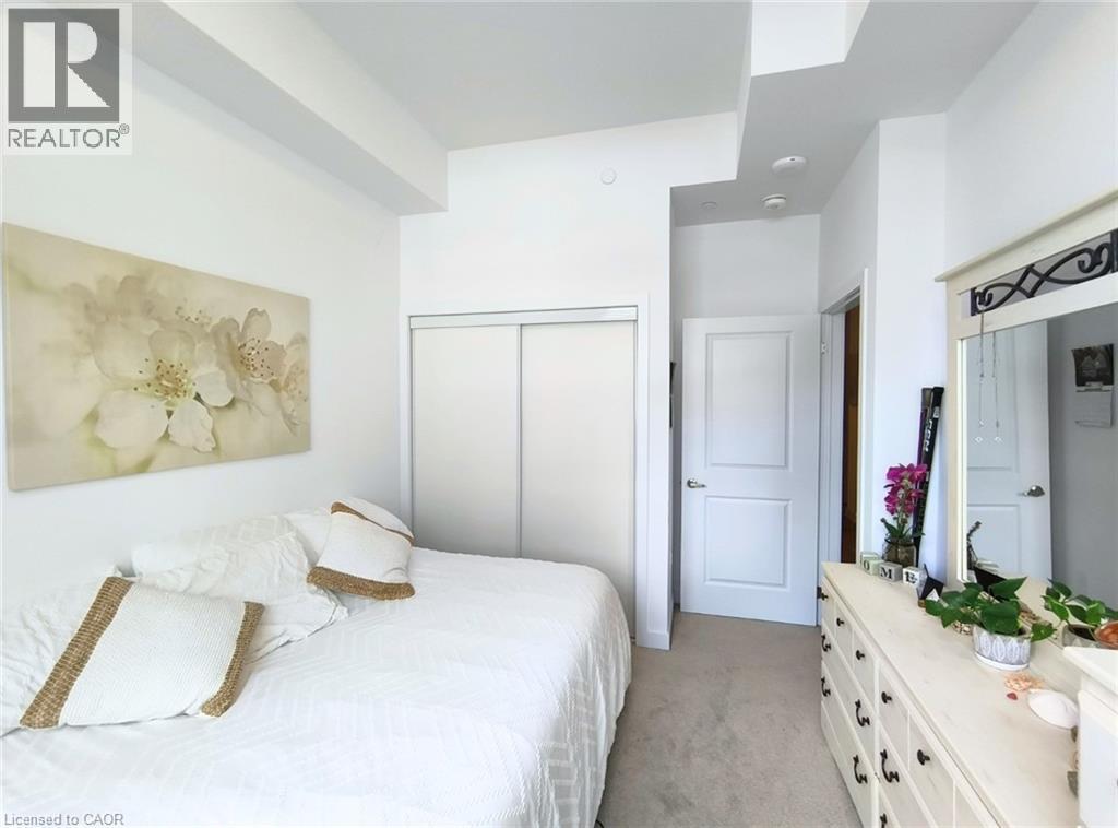 A bedroom with a large bed and a dresser with a mirror.
